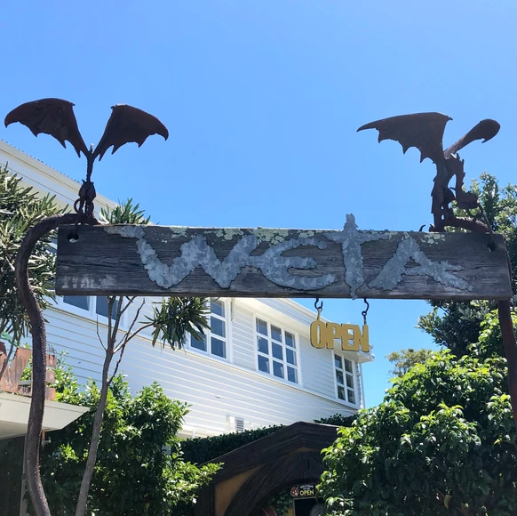 Wētā Cave sign at the entrance of the world-renowned special effects studio in Wellington, New Zealand—home to movie magic from The Lord of the Rings and more