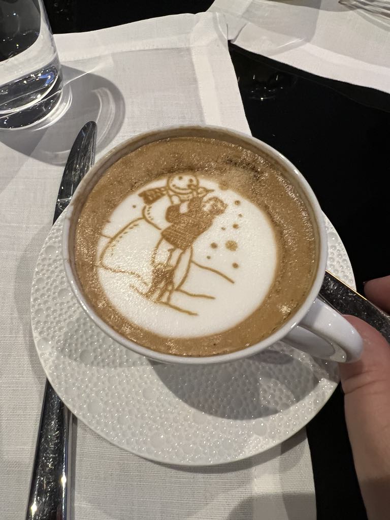 Beautiful beverage art in a cappuccino at a luxury hotel café, showcasing intricate latte designs that enhance the guest dining experience.