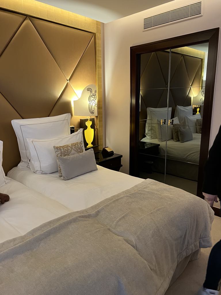 Charming in-room welcome treat featuring French pastries and a Paris guidebook at a luxury hotel, offering a warm and personalized arrival experience for guests exploring the City of Light.