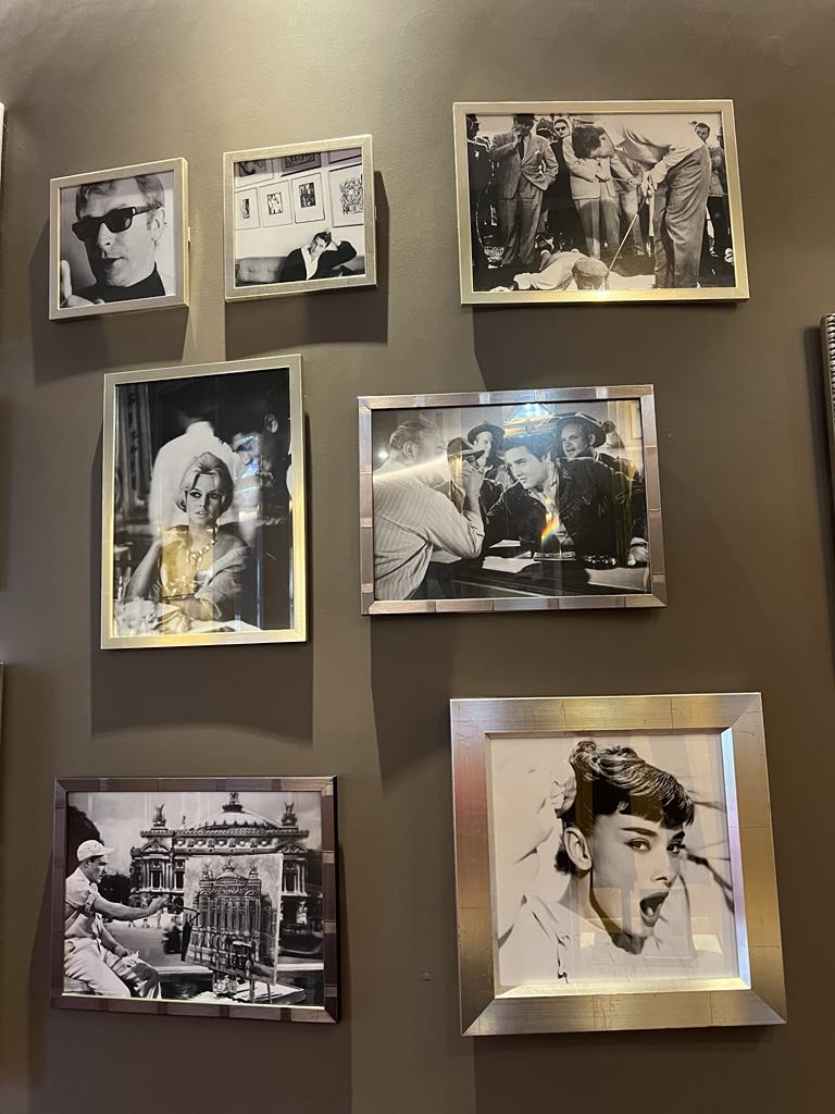 Wall of fame at a luxury hotel featuring photos of iconic Hollywood stars who have stayed at or dined in the historic property, celebrating its glamorous legacy and celebrity appeal.