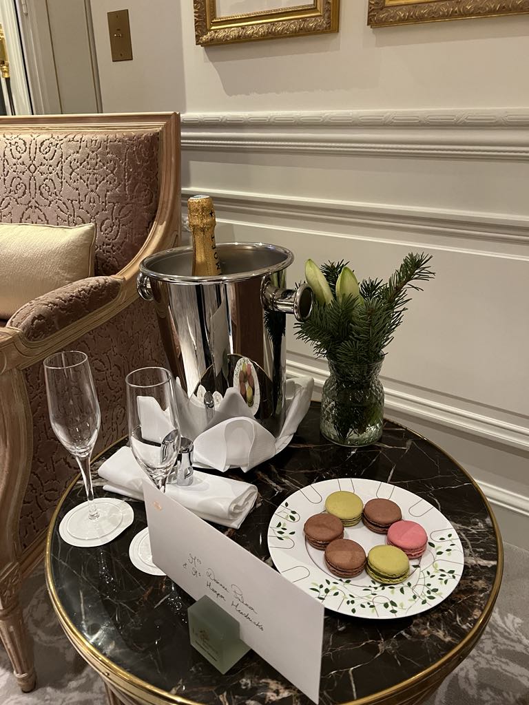 Elegant welcome gift of colorful French macarons left in-room at a luxury Paris hotel, offering guests a sweet taste of local hospitality upon arrival.