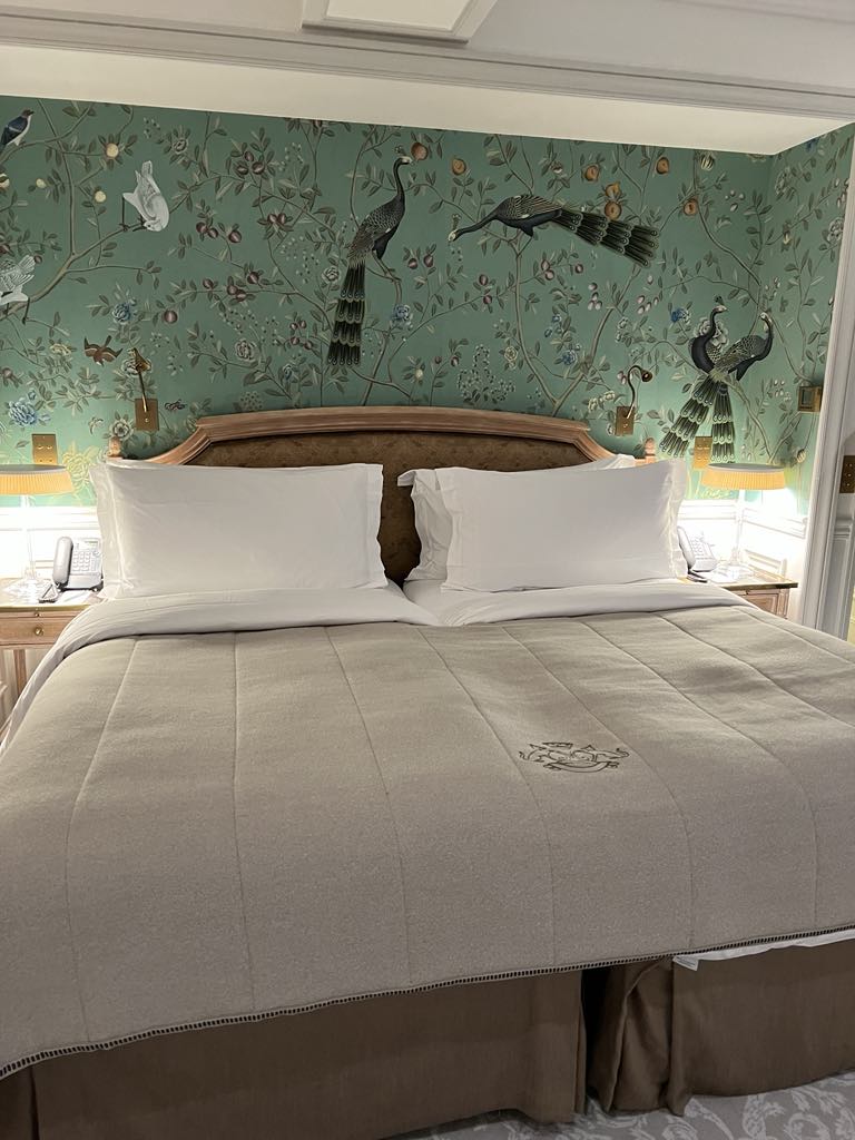 Lavish guest room at Le Meurice Paris, showcasing timeless Parisian elegance with 18th-century-inspired decor, plush bedding, and upscale amenities in a historic five-star hotel.