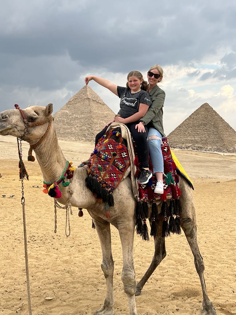 Girl Harper on Camel in front pf Pyramids in Egypt