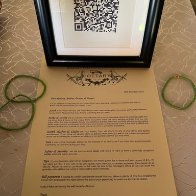 Personalized welcome letter and traditional Maasai beaded bracelets at Cottar’s 1920s Safari Camp in Kenya, offering a warm and authentic arrival experience.