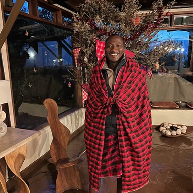Expert safari guide Mako “Mr. Fantastic” at Cottar’s 1920s Camp in Kenya, leading a luxury family wildlife adventure in the African bush.
