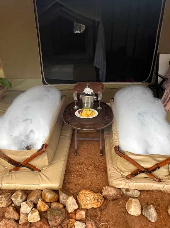 Luxury bush bath setup at Cottar’s 1920s Safari Camp in Kenya, featuring a freestanding canvas tub with scenic views of the savannah—an unforgettable safari spa experience.