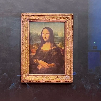 The iconic Mona Lisa by Leonardo da Vinci on display at the Louvre Museum in Paris, a must-see highlight of any cultural visit to France.
