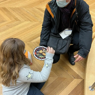 Teen traveler Harper exploring the Louvre on a guided scavenger hunt, combining art education and interactive fun during a luxury family trip to Paris.