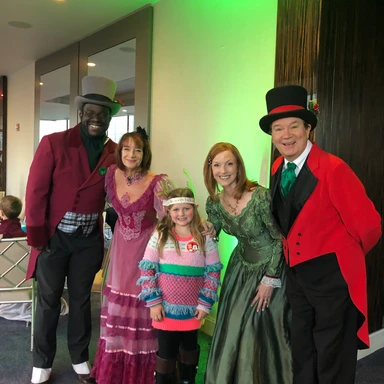 Kid traveler Harper caroling with a group of holiday singers at Trump Hotel Chicago, enjoying a magical Christmas experience during a luxury family stay.