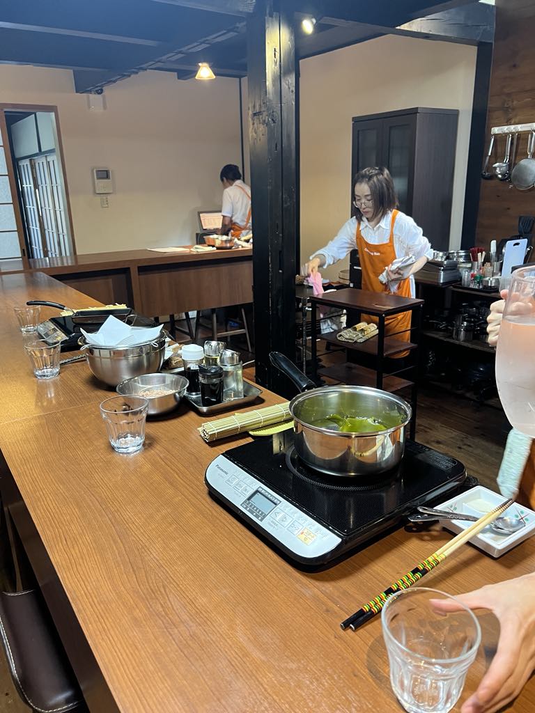 Teen traveler Harper learning to make authentic Japanese cuisine during a hands-on cooking class in Kyoto, embracing cultural immersion as part of her luxury family adventure in Japan.