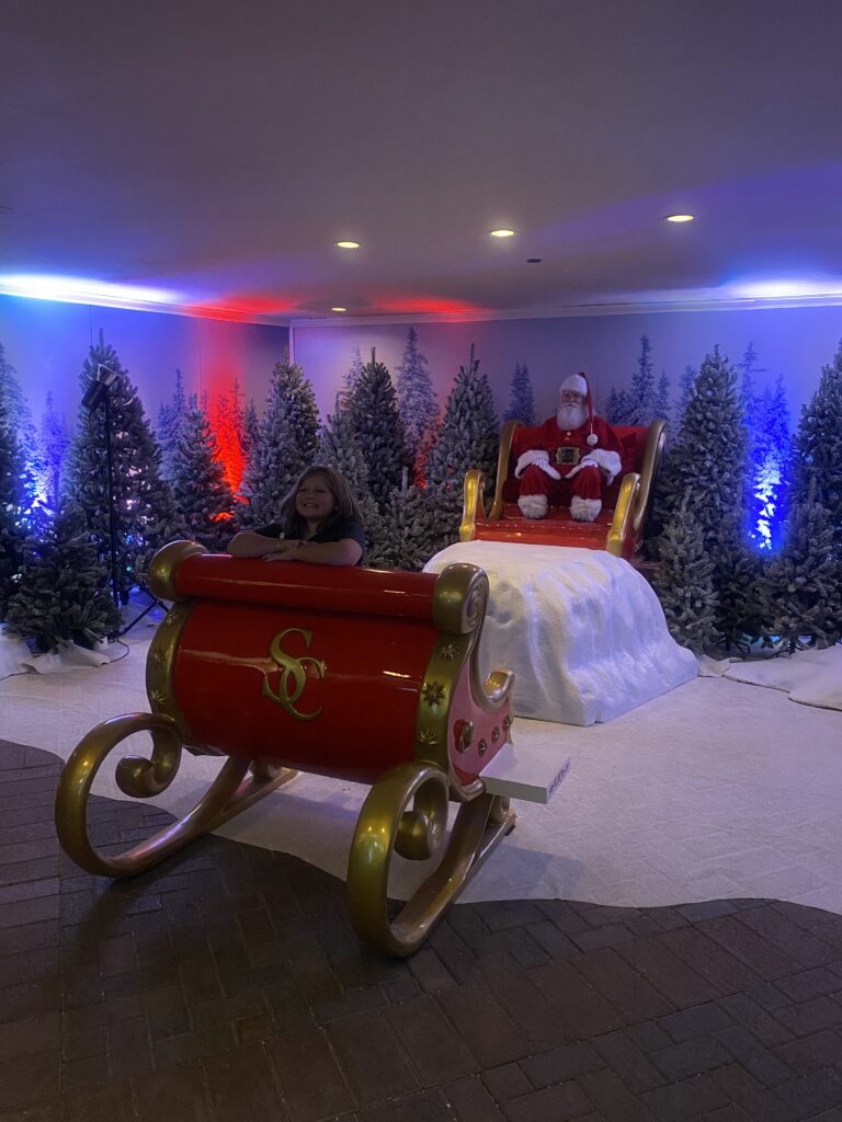 kid traveler Harper meeting Santa Claus at the Fairmont Scottsdale Princess during the “Christmas at the Princess” event, enjoying a magical holiday moment on a luxury family getaway.