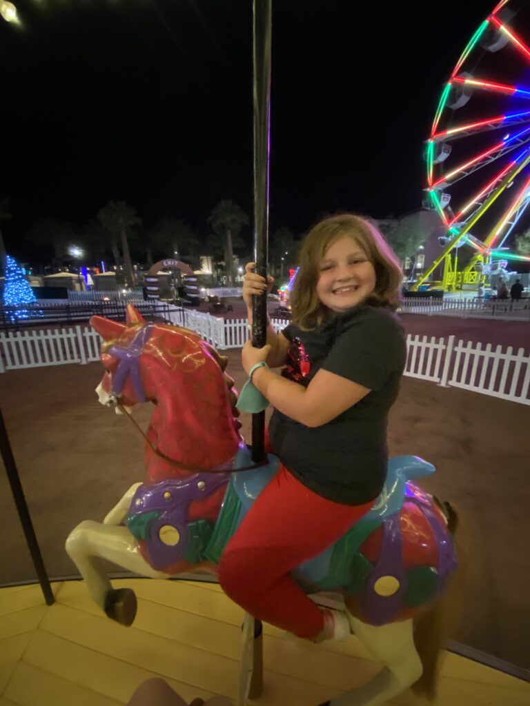 kidtraveler Harper enjoying a holiday carousel ride at the Fairmont Scottsdale Princess during the magical “Christmas at the Princess” family event in Scottsdale, Arizona.
