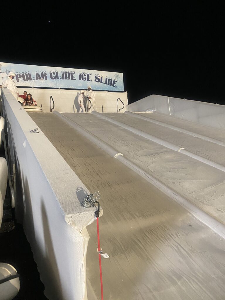 Exciting ice slide attraction at the Fairmont Scottsdale Princess during the “Christmas at the Princess” event, providing festive winter fun for kids and teens at a luxury holiday celebration.