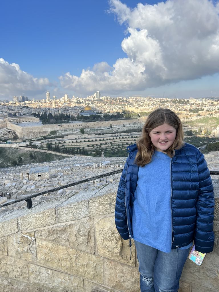 Teen girl Harper with the City of Jerusalem behind her in Israel