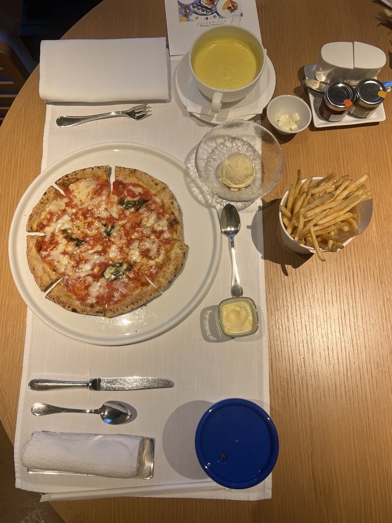 Kid-friendly personal pizza from the children’s menu at a luxury family hotel, featuring a classic favorite perfect for young travelers.