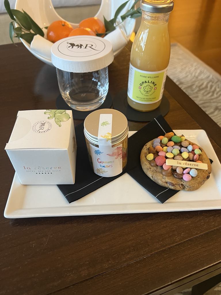 Elegant welcome treats presented in a luxury hotel room, featuring gourmet sweets, thoughtful details, and personalized amenities to greet arriving guests with warmth and style.
