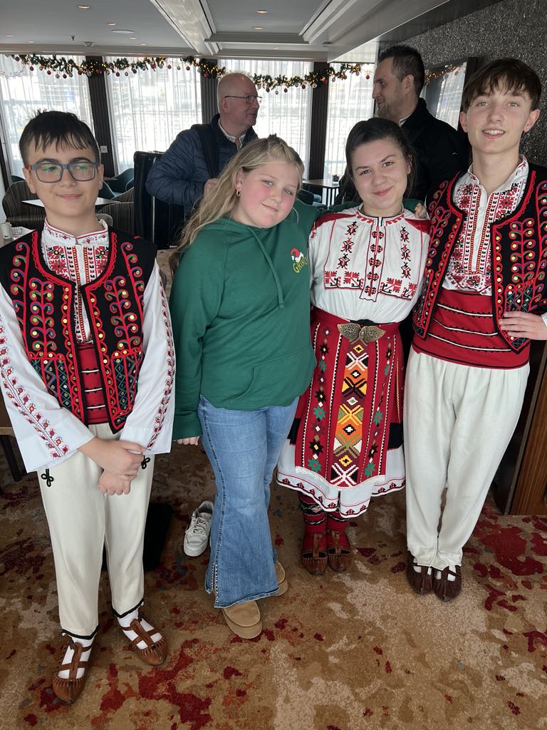 Harper with local dancers in Bulgaria on Amabella