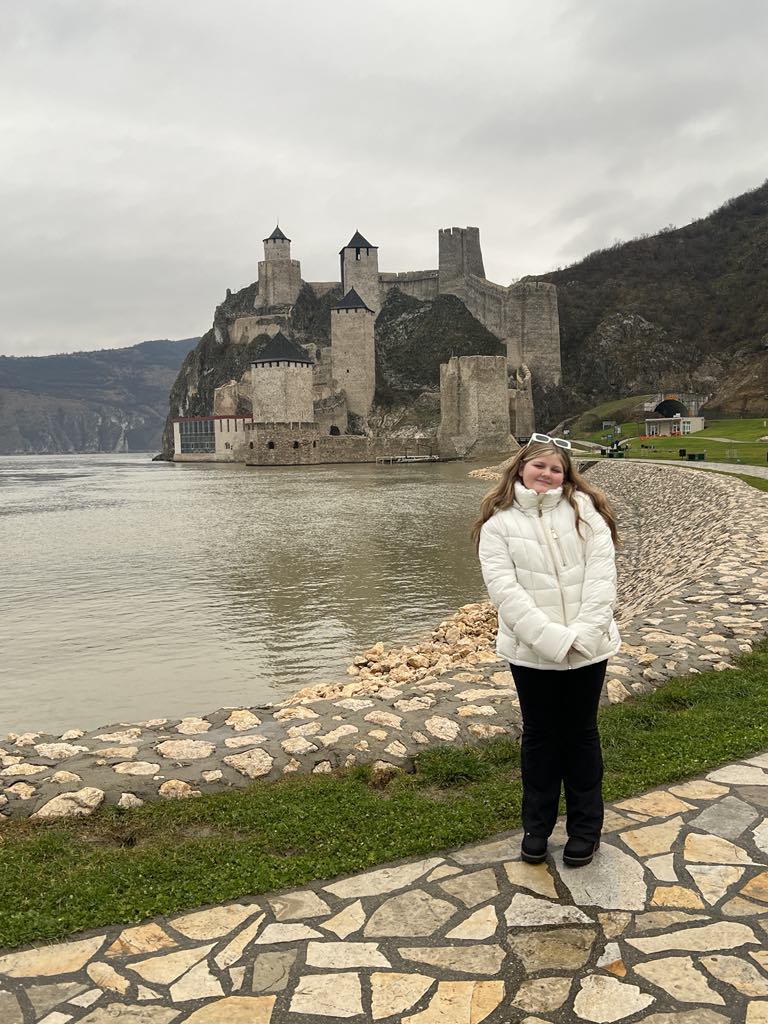 Teen girl harper in front of Golubac Fortress