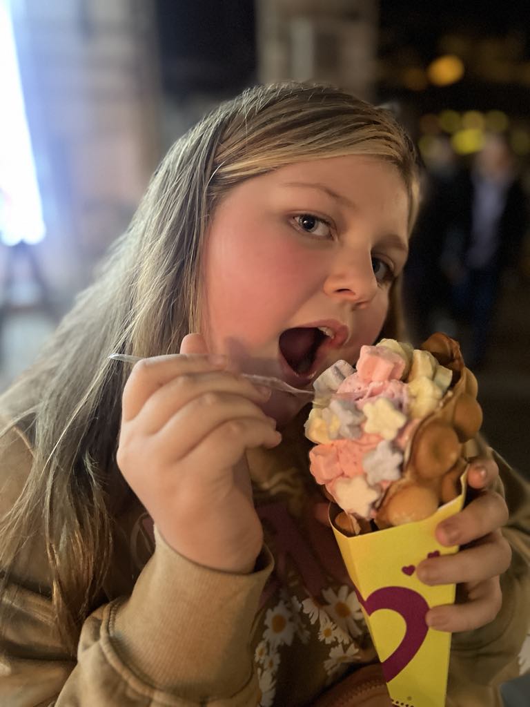 Teen girl Harper eating a bubble waffle