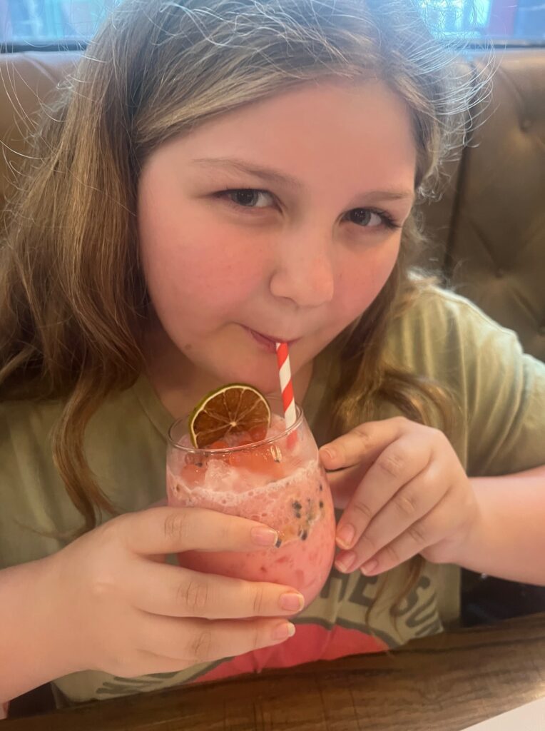 Harper sipping a pretty drink