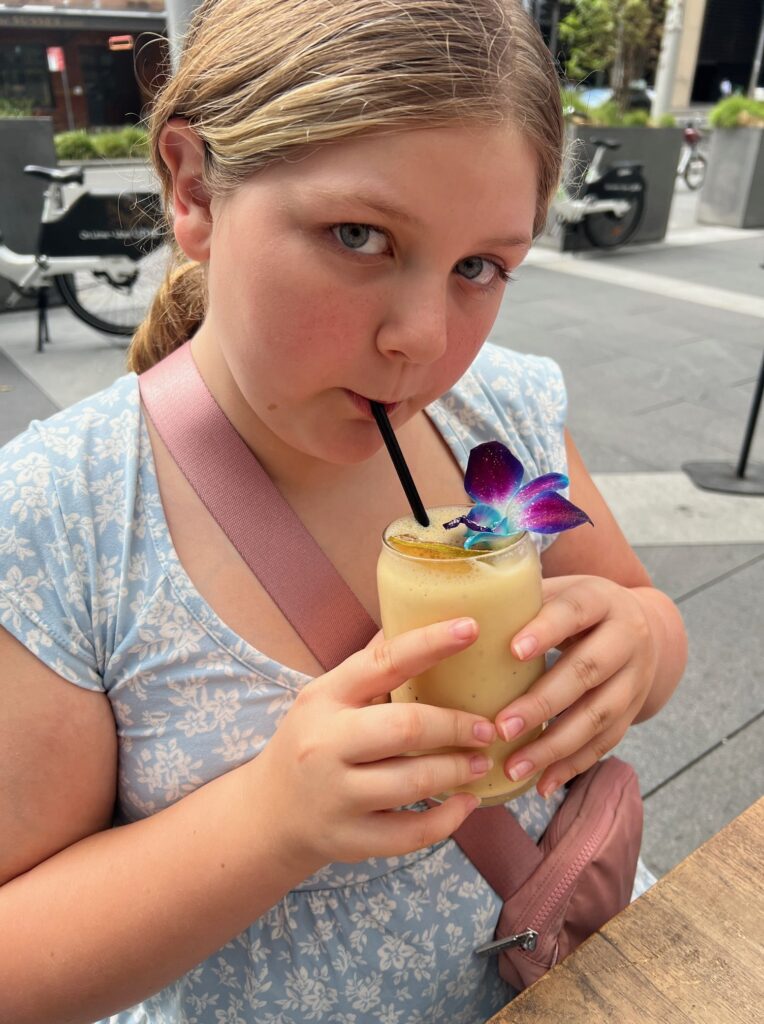 Girl sipping smoothie with flower in it