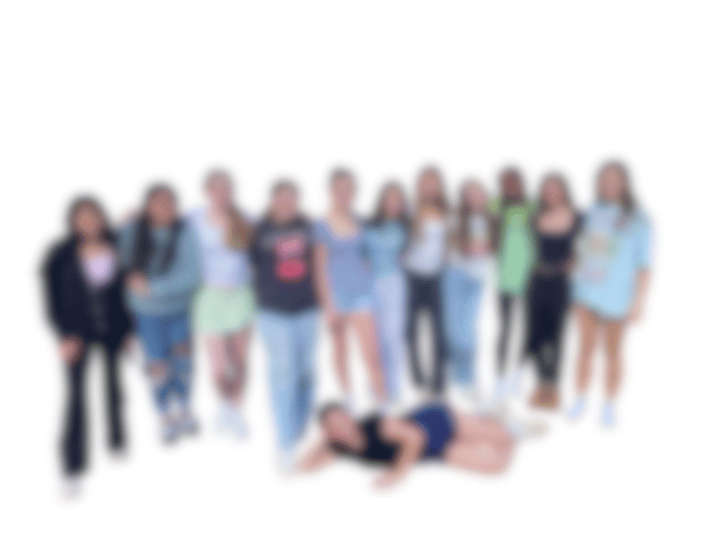 Diverse group of young adults posing together outdoors.