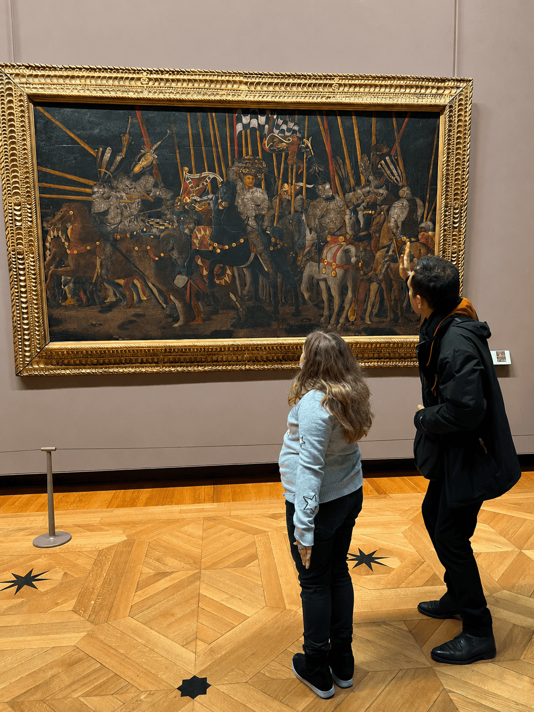 Harper exploring a historic painting with a museum guide