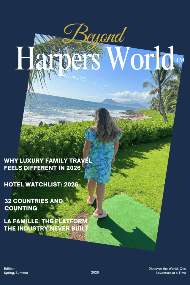 Magazine cover titled “Harpers World” showing a person walking toward the ocean on a grassy path with palm trees and a coastal view; cover lines reference luxury family travel in 2026, a hotel watchlist, global travel milestones, and the La Famille platform.